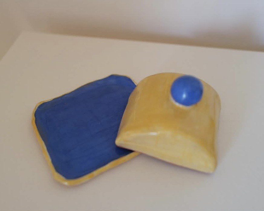 Blue and yellow butter dish, lid resting beside its tray