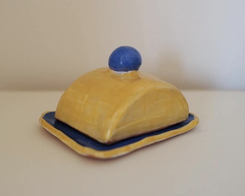 Blue and yellow butter dish, front view with lid on
