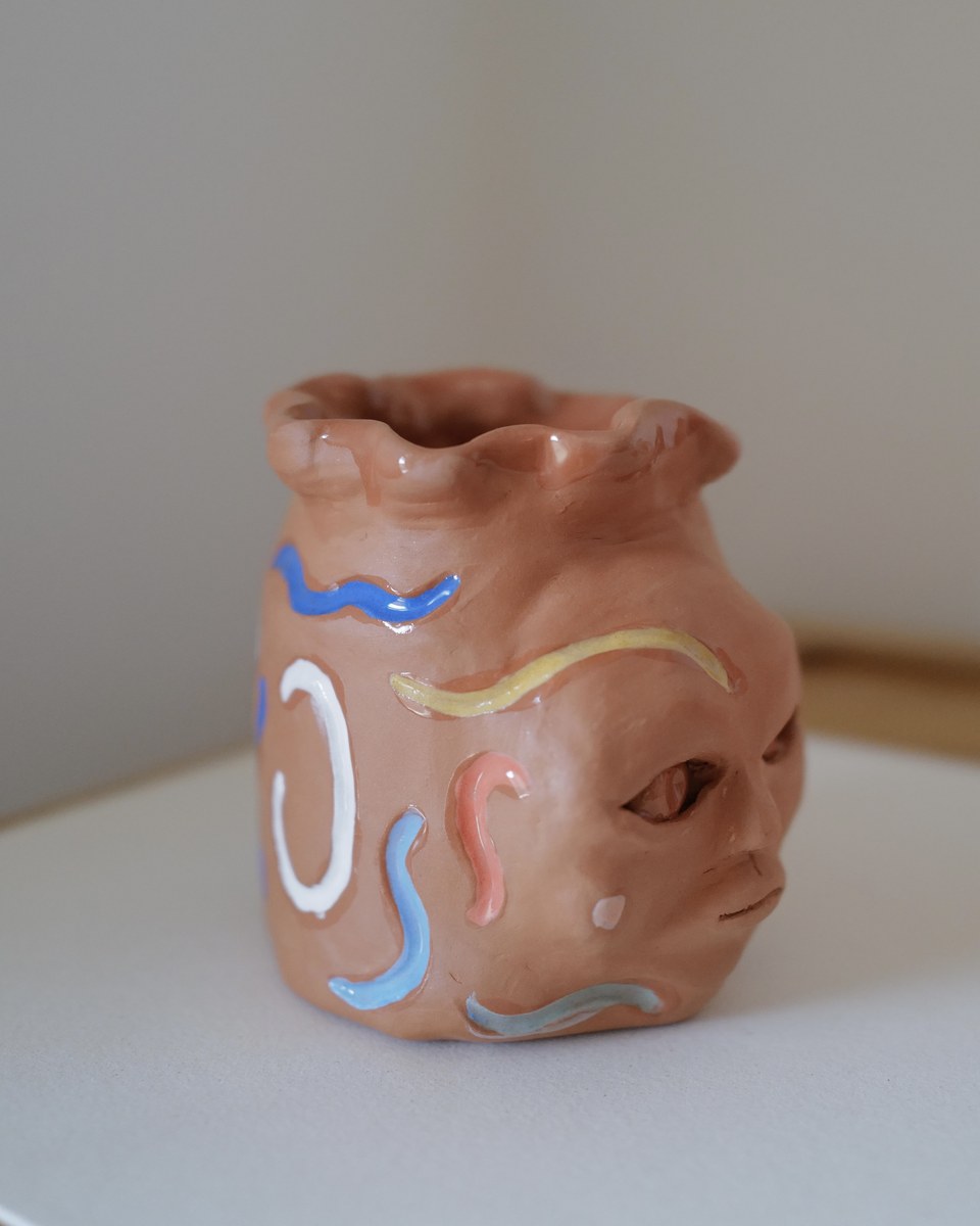 Whimsical face vase, side angle
