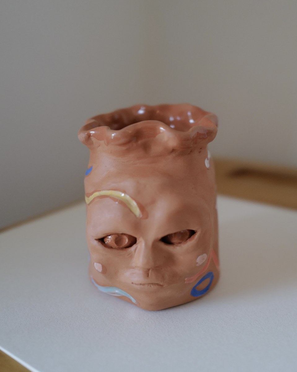 Whimsical face vase, front angle