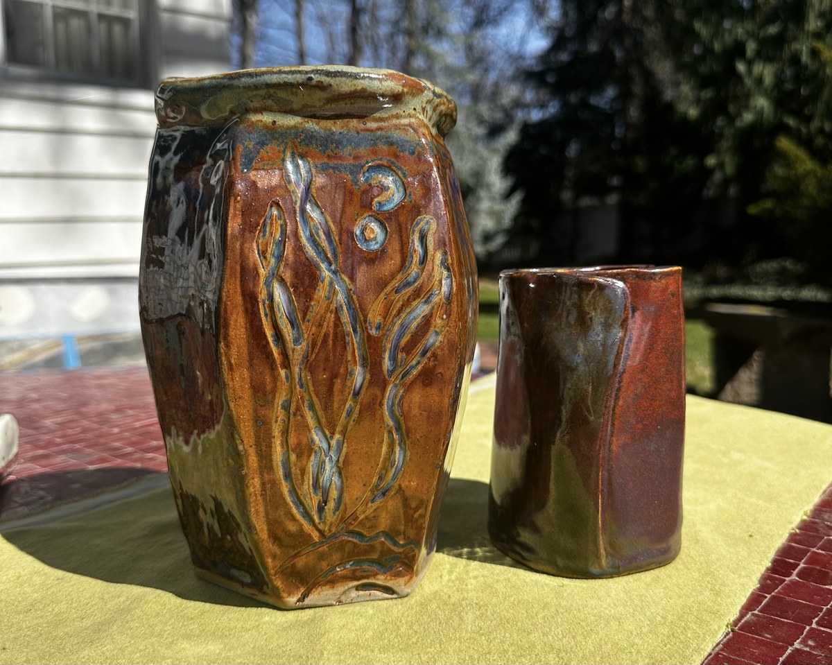 Two vases with a carved wavy line pattern