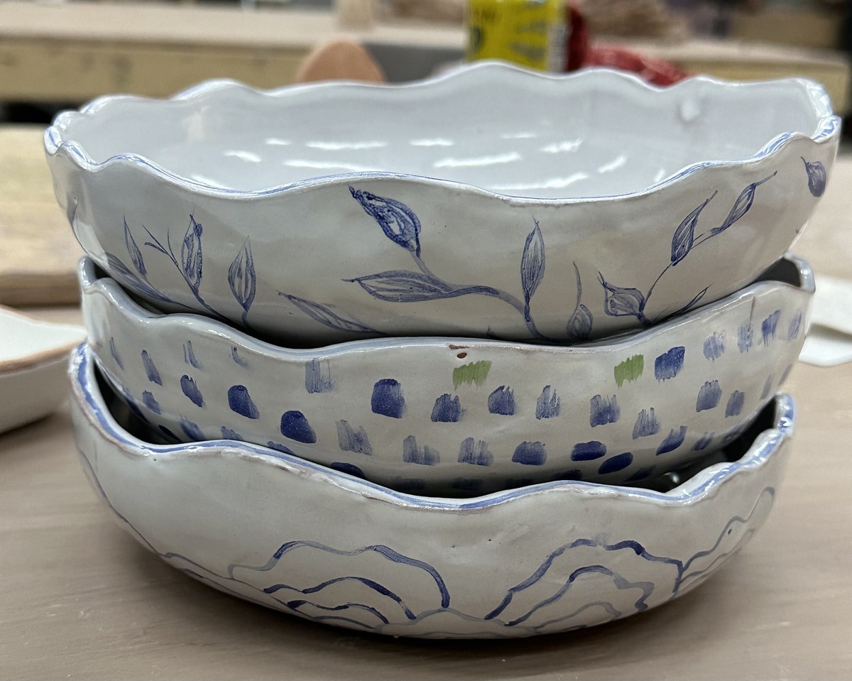 Three nesting bowls with blue leaf and dot patterns
