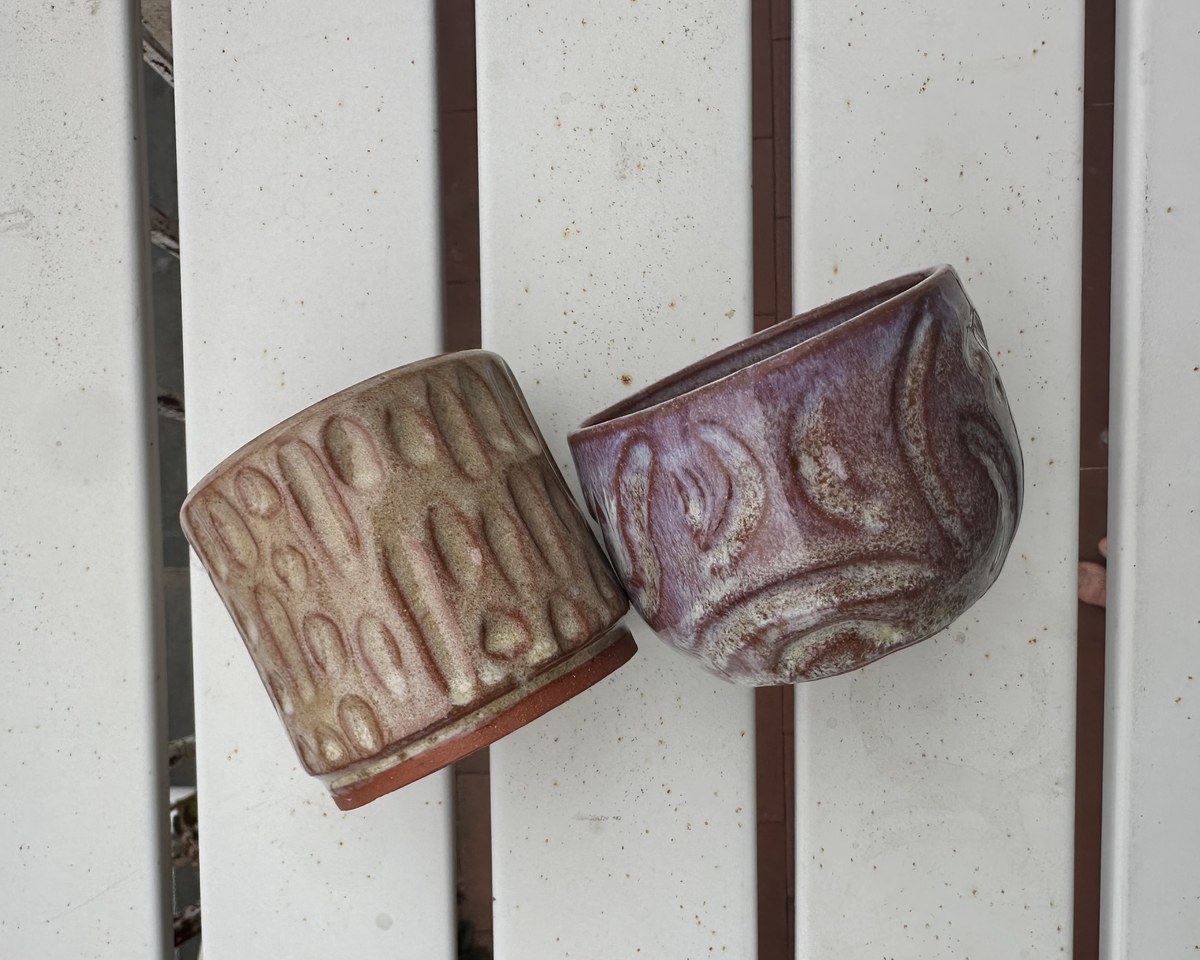 Two textured cups, one brown and one purple