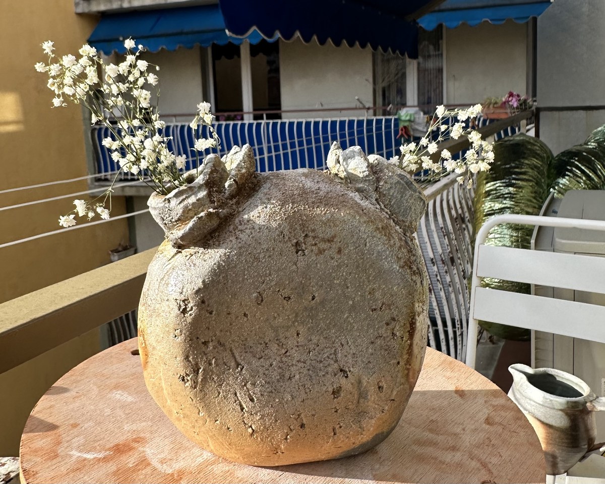 Large round wood-fired vase with dried baby's breath
